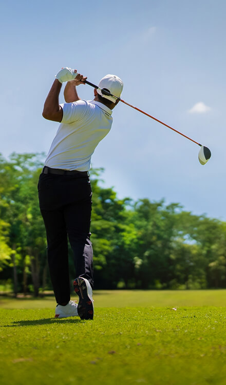 man following through on golf swing