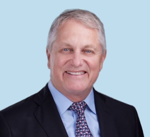 Thomas L. Bernasek, MD professional headshot wearing black suit and textured tie