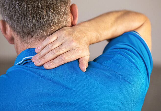 patient holding neck experiencing whiplash